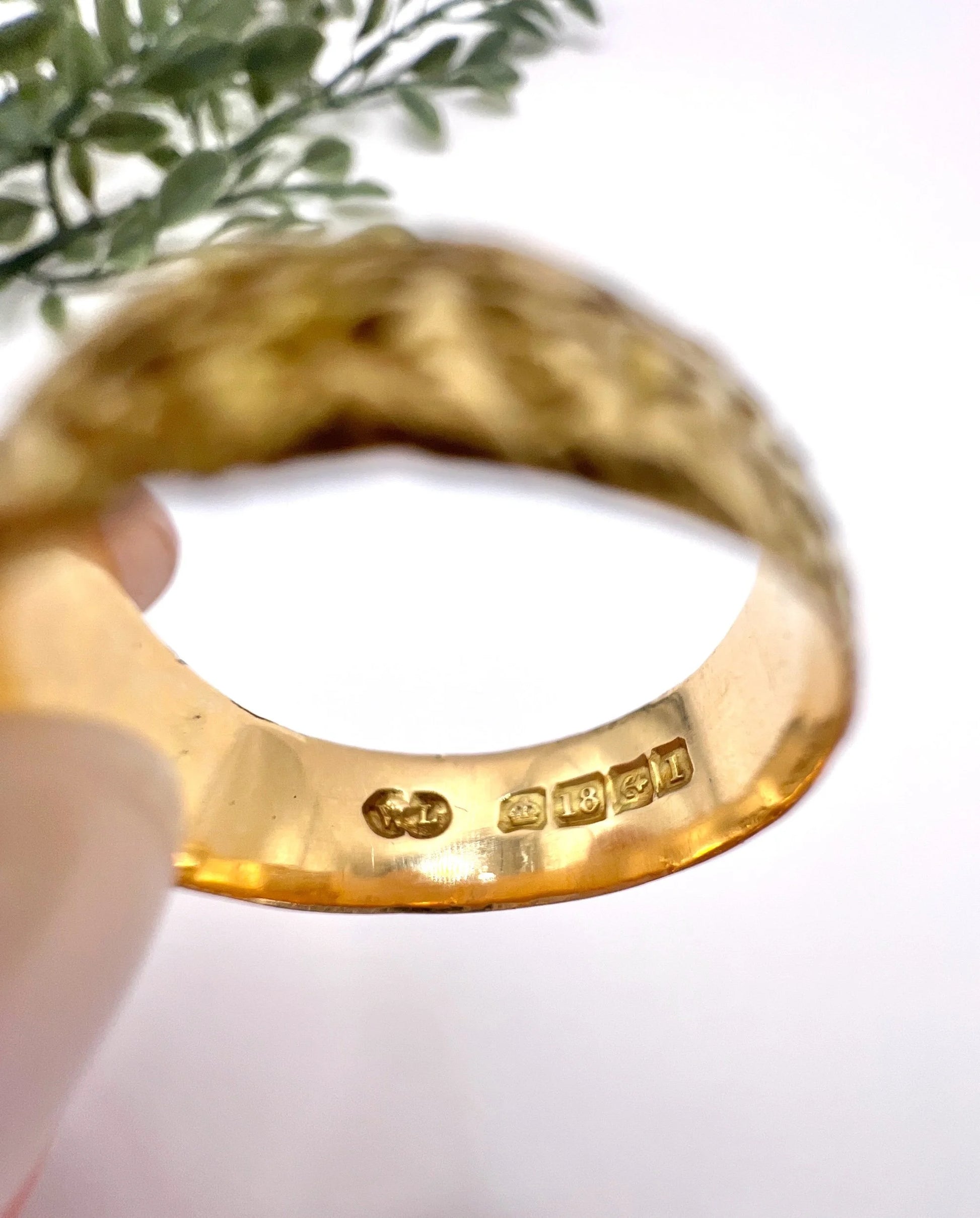An 18 carat gold Birmingham 1910 hallmark inside a yellow gold ring shank