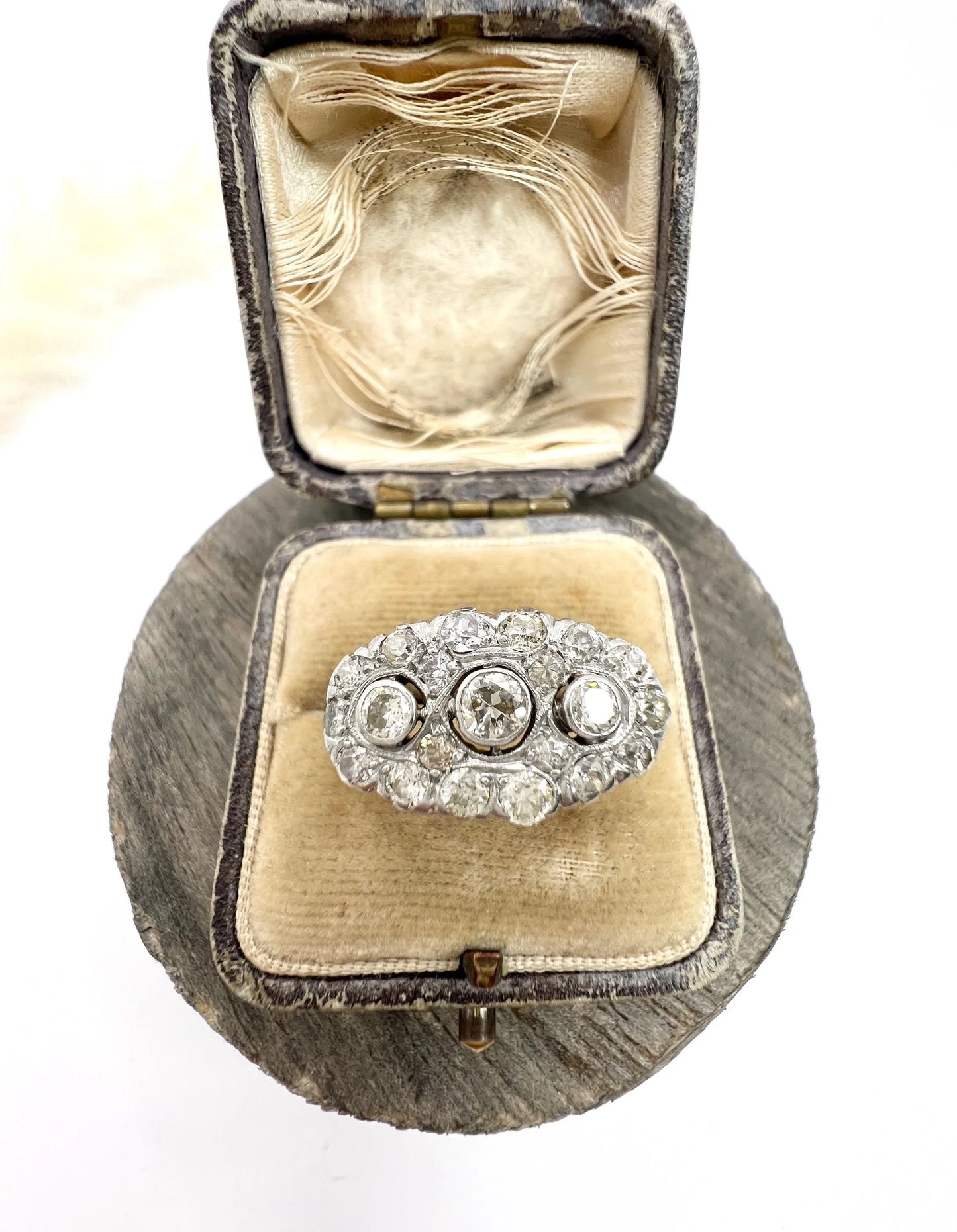 A diamond triple cluster ring in yellow and white gold, in a ring box
