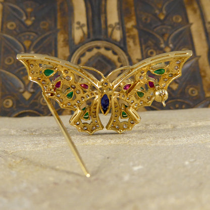 Contemporary diamond emerald ruby and sapphire butterfly brooch in 18ct gold