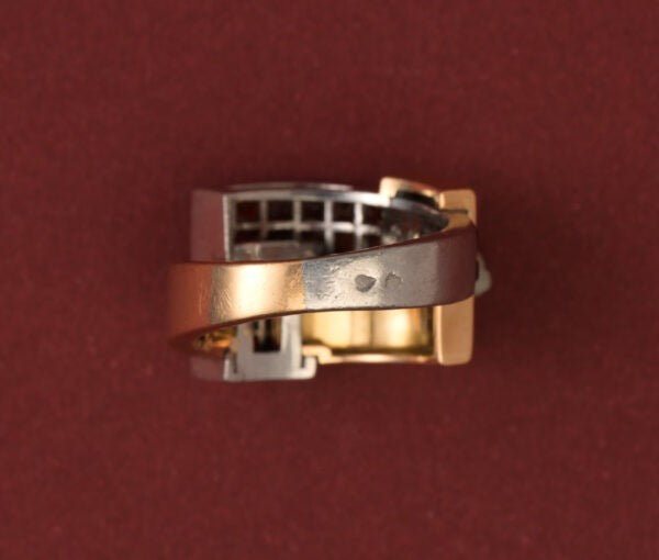 Art Deco Garnet Set Ring; geometrical construct in 18ct gold and platinum, set with 3.60cts square-cut blind-set hessonite garnets. France, Numbered 32827. 