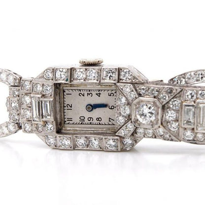 Art Deco 7ct Diamond and Platinum Bracelet Cocktail Watch; diamond bracelet with diamond set sliding panel revealing watch face, 7.00 carats, Circa 1930