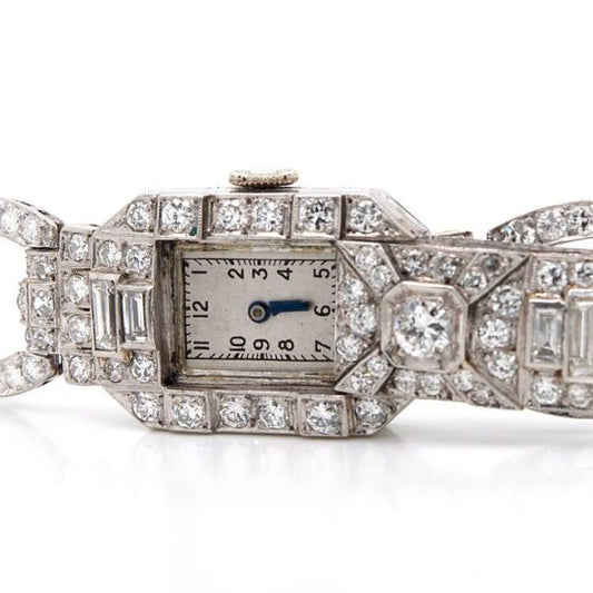 Art Deco 7ct Diamond and Platinum Bracelet Cocktail Watch; diamond bracelet with diamond set sliding panel revealing watch face, 7.00 carats, Circa 1930