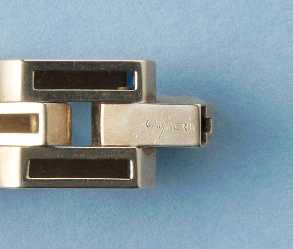 Cartier Gold Retro Bracelet Set With Sapphires; industrial design tank link gold bracelet set with thirty-one French square cut sapphires, Signed and numbered, Circa 1940