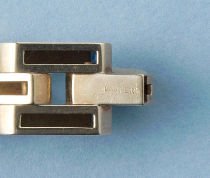 Cartier Gold Retro Bracelet Set With Sapphires; industrial design tank link gold bracelet set with thirty-one French square cut sapphires, Signed and numbered, Circa 1940