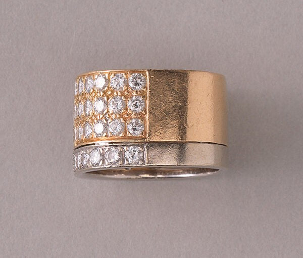 Vintage Diamond and Bi Colour 18ct Gold Band Ring; 18ct yellow and white gold juxtaposed angle pavé set with 48 brilliant cut diamonds, 2.50 carat total, by the Swiss master jeweller Paul Binder. Circa 1970s, Zurich, Switzerland