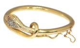 Antique Victorian Diamond, Ruby and 18ct Yellow Gold Snake Bangle Bracelet; twelve rose-cut diamond set head, with ruby set eyes, Circa 1880