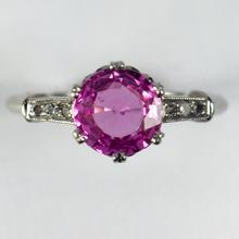 Pink Sapphire, Diamond and Platinum Solitaire Ring; set with a 1.45ct round faceted pink sapphire, with single-cut diamond set shoulders