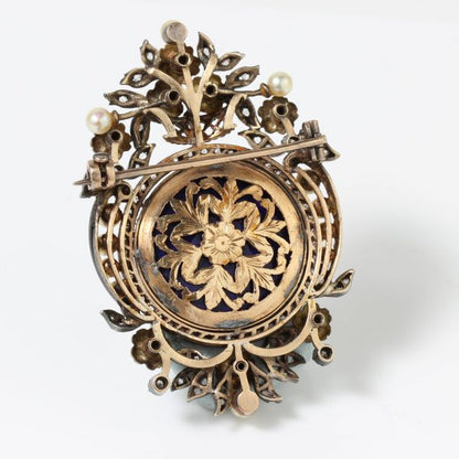 Antique Victorian Enamel Portrait Brooch; enamel portrait of young girl decorated with diamonds, pearls and enamel flowers, in silver and 15ct gold, Circa 1850s