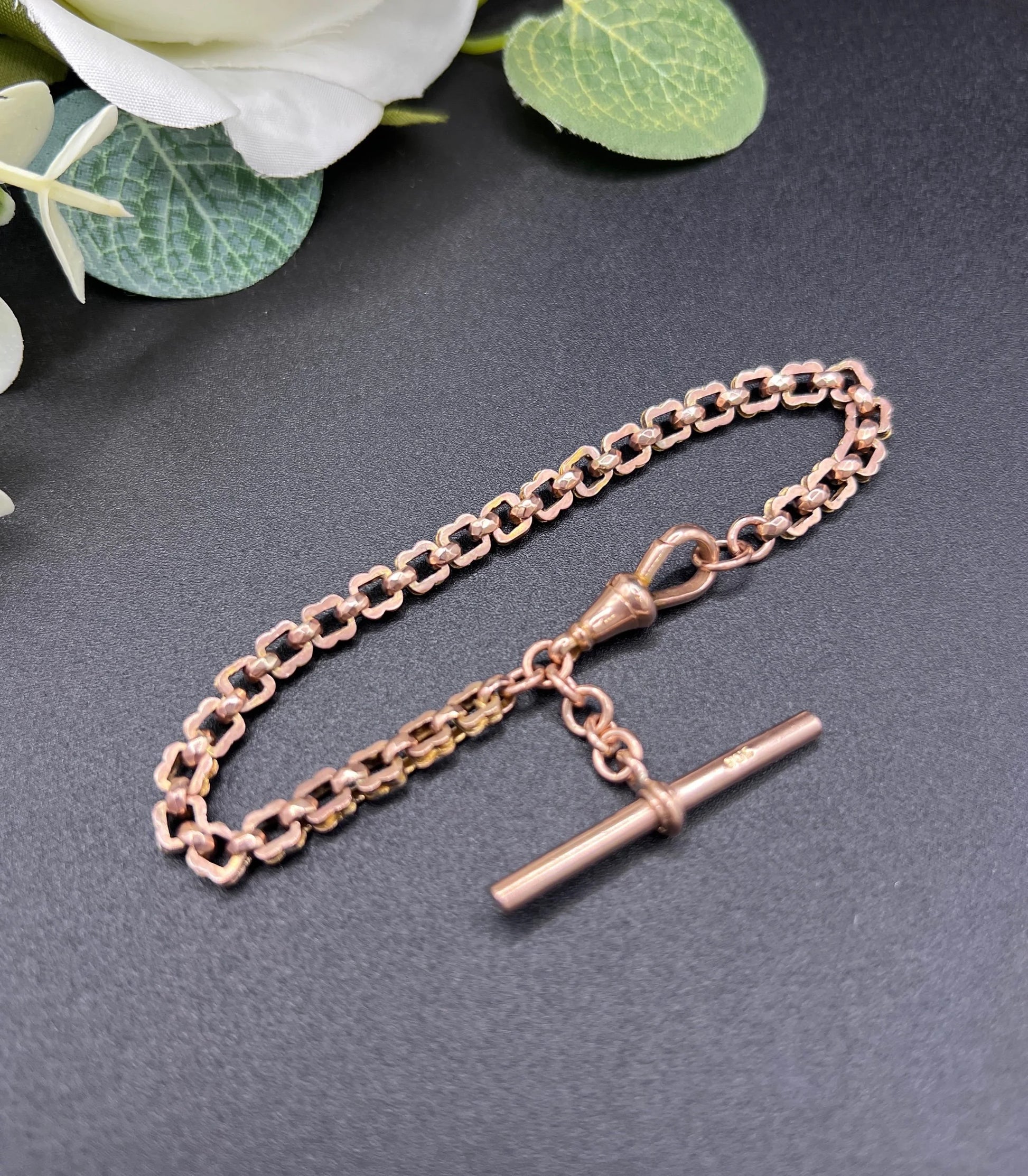 A fancy link rose gold bracelet with a T-bar and dog clip clasp