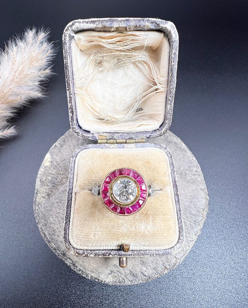 Vintage Antique Art Deco Diamond and Ruby Halo Target Cluster Engagement Ring, 0.65ct diamond framed by border of calibre red rubies in platinum and 18ct yellow gold. Circa 1920s