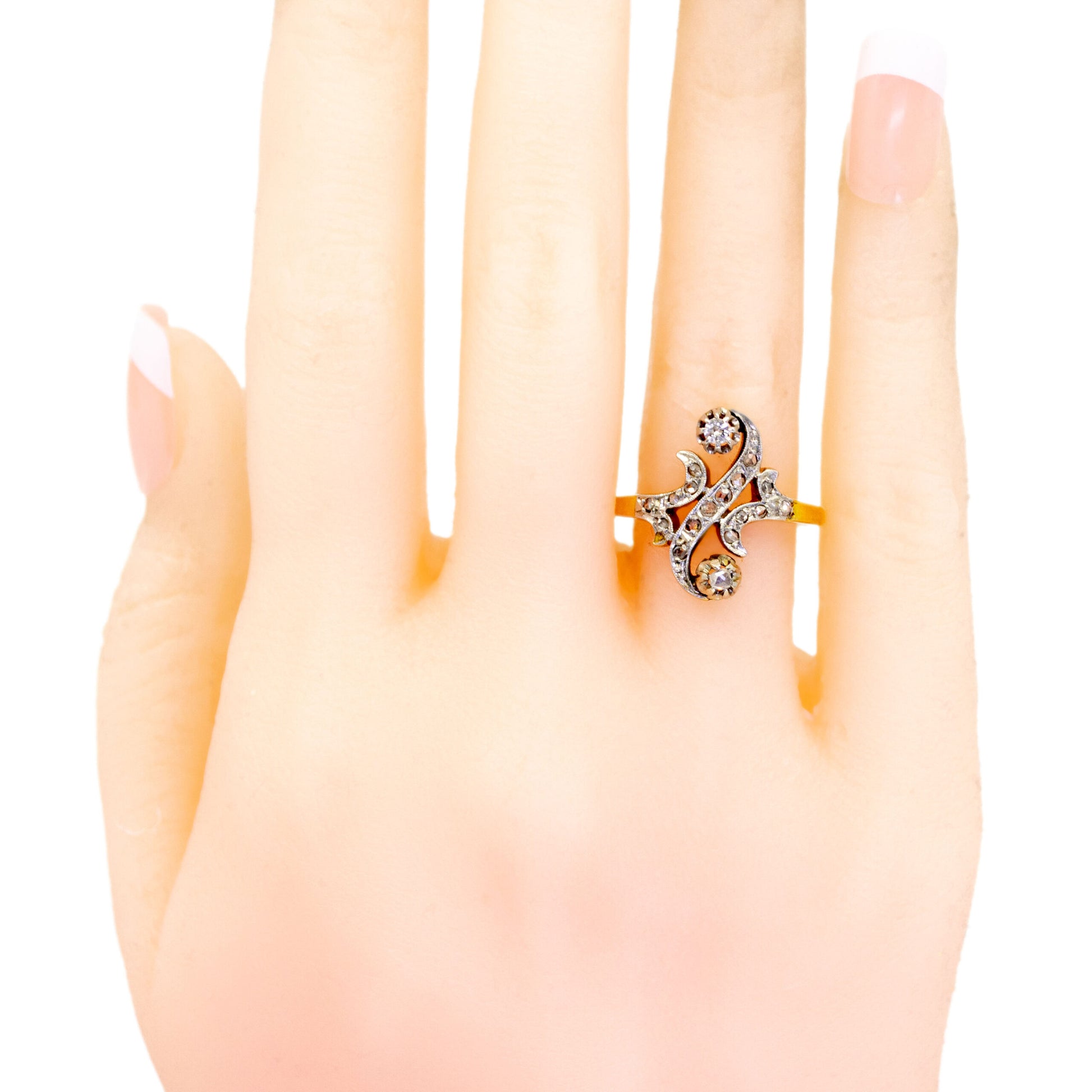 A yellow gold and platinum diamond fancy scroll design ring, modelled on a hand