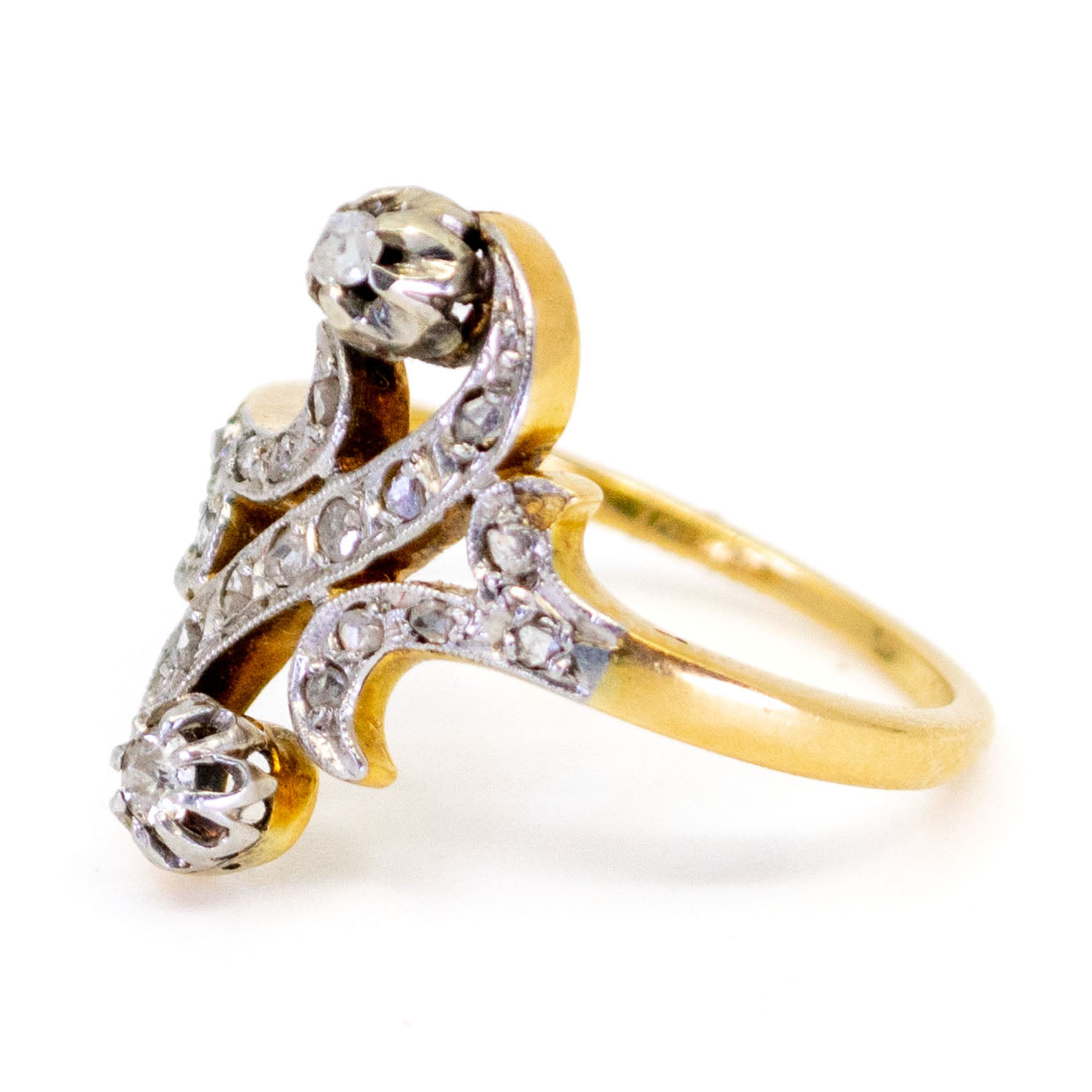 A yellow gold and platinum diamond fancy scroll design ring