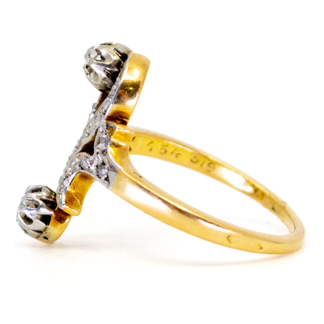 A yellow gold and platinum diamond fancy scroll design ring