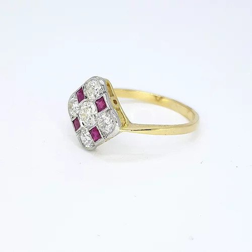 Ruby and Diamond Checkerboard Cluster Ring; five circular diamonds and four square faceted rubies arranged in a diamond-shaped checkerboard design, mounted in platinum to an 18ct yellow gold shank
