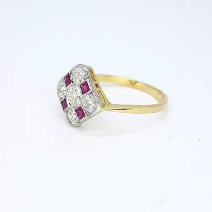 Ruby and Diamond Checkerboard Cluster Ring; five circular diamonds and four square faceted rubies arranged in a diamond-shaped checkerboard design, mounted in platinum to an 18ct yellow gold shank
