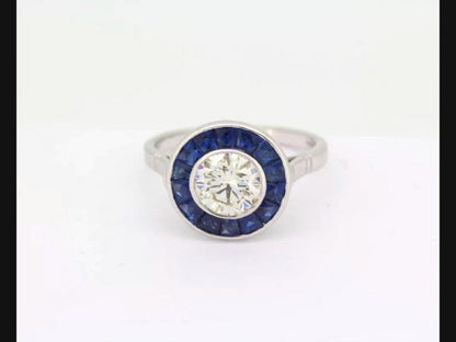 Vintage Art Deco Style Sapphire and Diamond Calibre Set Ring; round cut 1.21ct diamond encircled by sapphires.