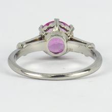 Pink Sapphire, Diamond and Platinum Solitaire Ring; set with a 1.45ct round faceted pink sapphire, with single-cut diamond set shoulders