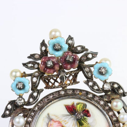 Antique Victorian Enamel Portrait Brooch; enamel portrait of young girl decorated with diamonds, pearls and enamel flowers, in silver and 15ct gold, Circa 1850s