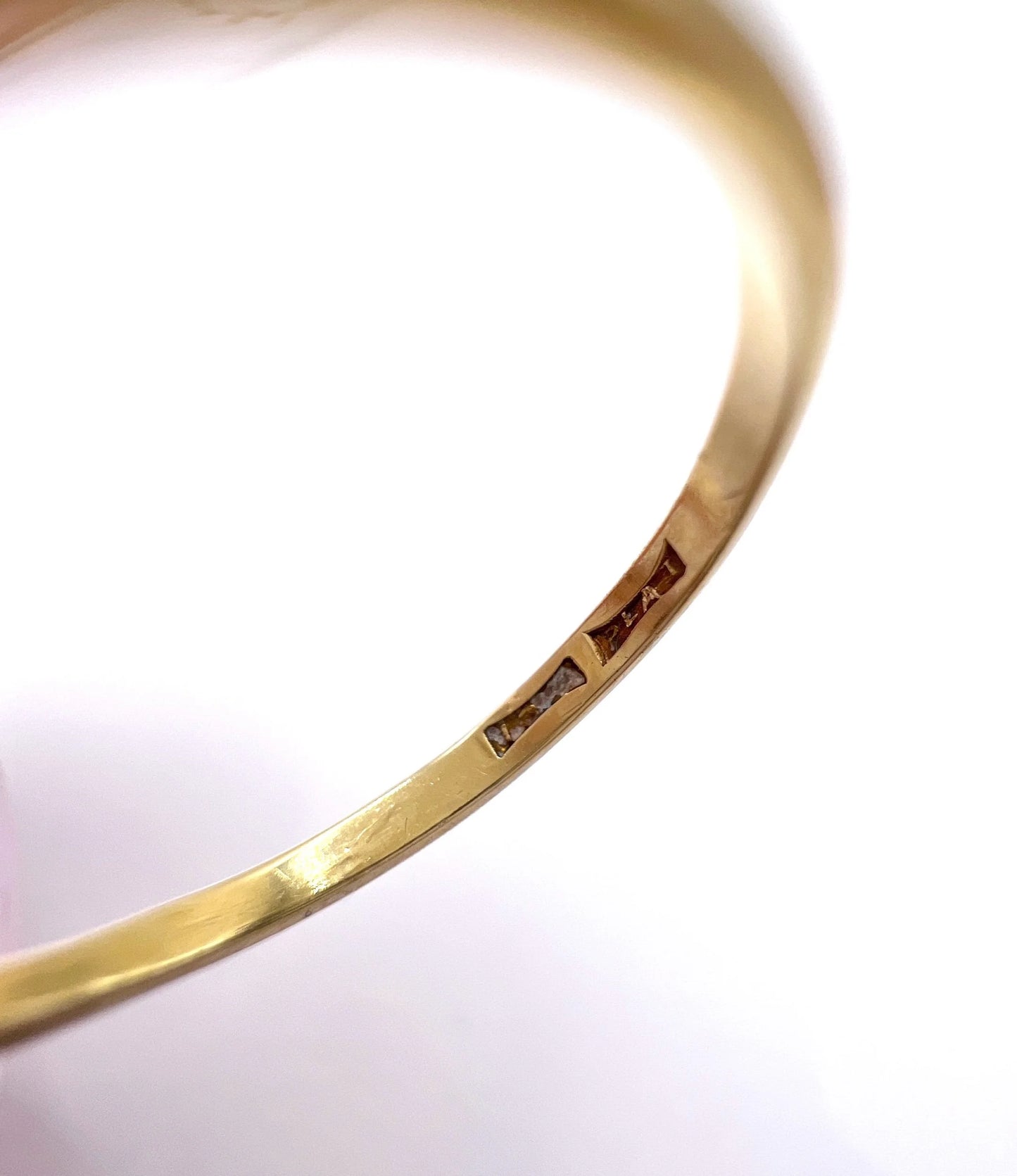 Close-up of stamps inside a yellow gold ring shank