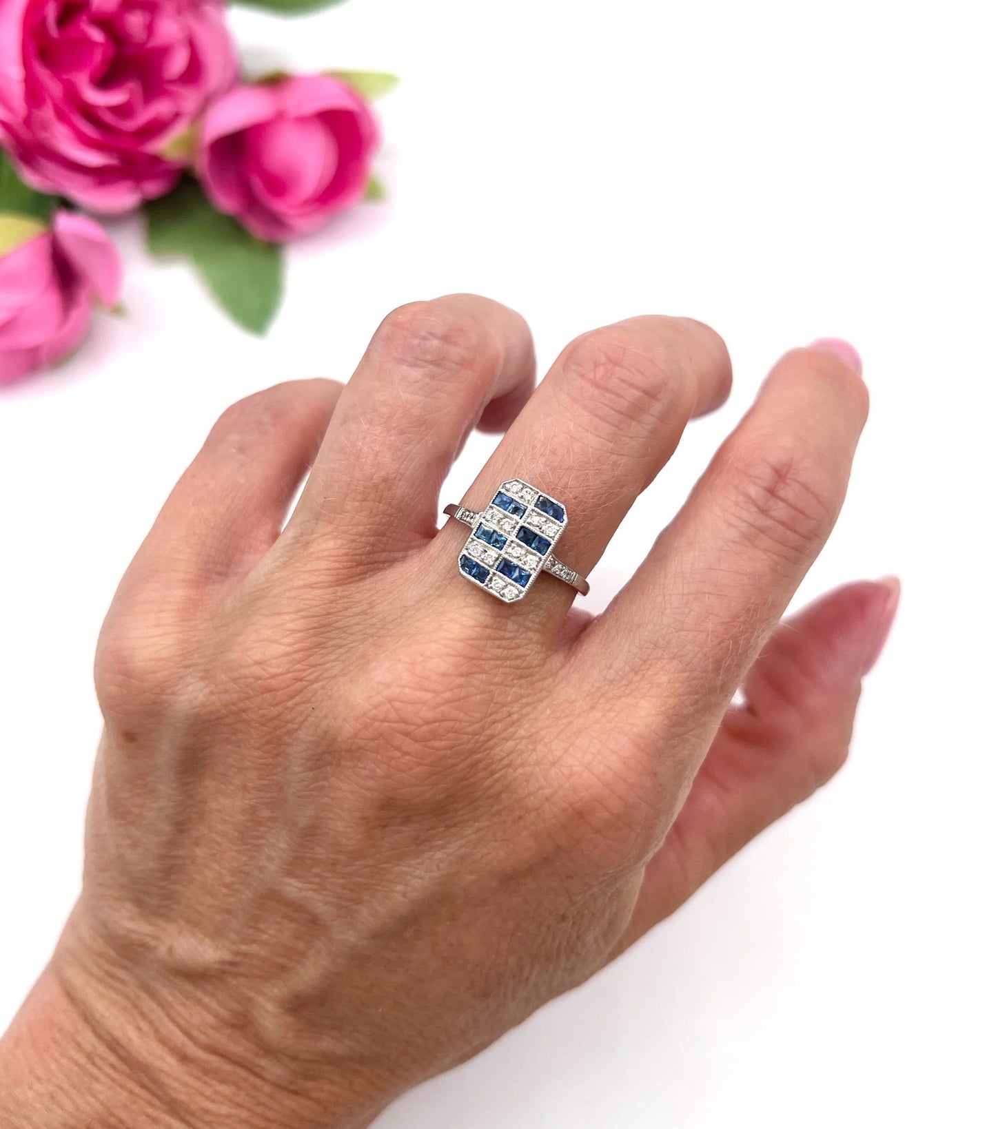 A sapphire and diamond tablet style ring in platinum, modelled on a hand