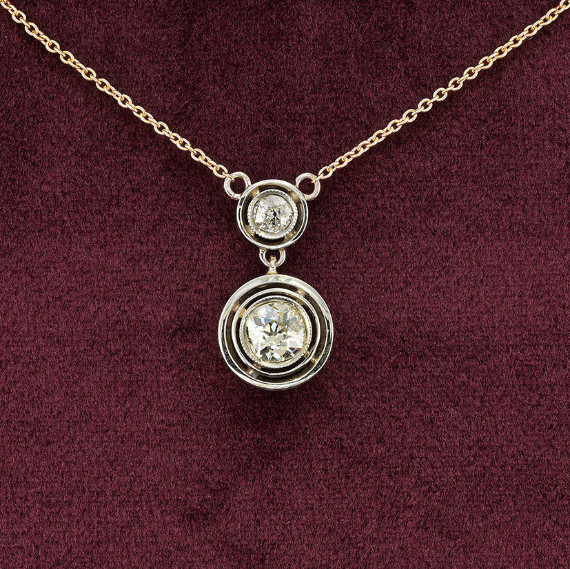 Art Deco 1.15ct Twin Old Cut Diamond Solitaire Target Pendant, 0.85ct old European-cut diamond topped with 0.30ct old mine-cut diamond in 18ct white gold target settings to fixed 18ct yellow gold trace chain