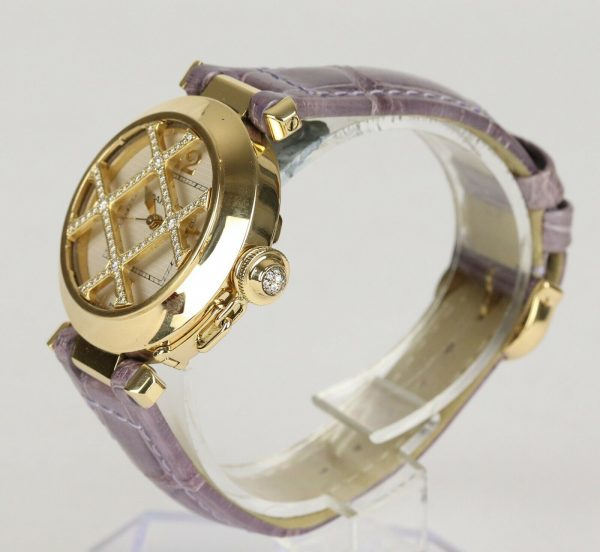Cartier Pasha de Cartier 18ct Yellow Gold 2399 Ladies Automatic 32mm Wrist Watch With Removable Diamond Grill, white textured dial, Arabic numerals at 12, 3, 6 and 9 o'clock, sapphire crystal glass and a pavé set diamond crown cap. On a Cartier purple leather strap, with a Cartier 18ct yellow gold pin buckle.
