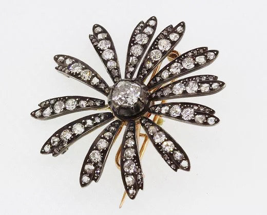 Antique Victorian 1.20ct Old Cut Diamond Daisy Flower Brooch; central 1.20 carat old-cut diamond, with diamond set petals, set in silver and backed with gold
