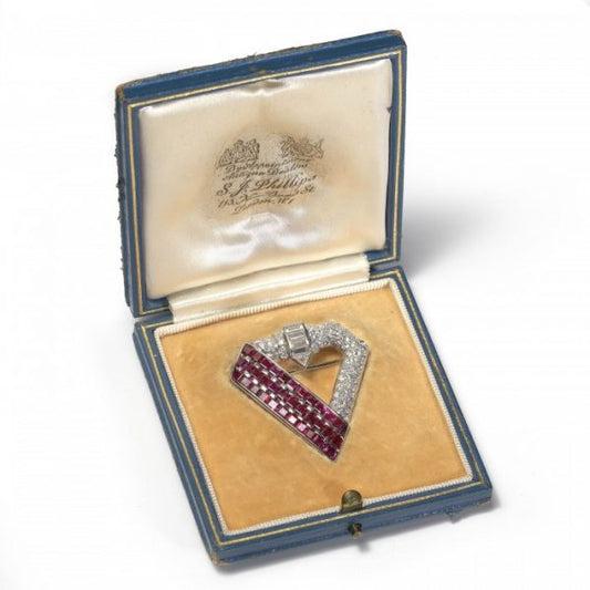 Vintage 1940s Ruby Diamond and Platinum Brooch; one side comprised of three columns of 5.25cts calibre-cut rubies, with 3.50cts fancy-cut and brilliant-cut diamonds set on the rest of the brooch