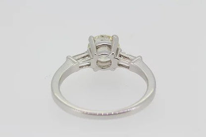 Diamond Solitaire Engagement Ring; central 1.22 carat round brilliant cut diamond with 0.24cts baguette cut diamonds to the shoulders, in 18ct white gold