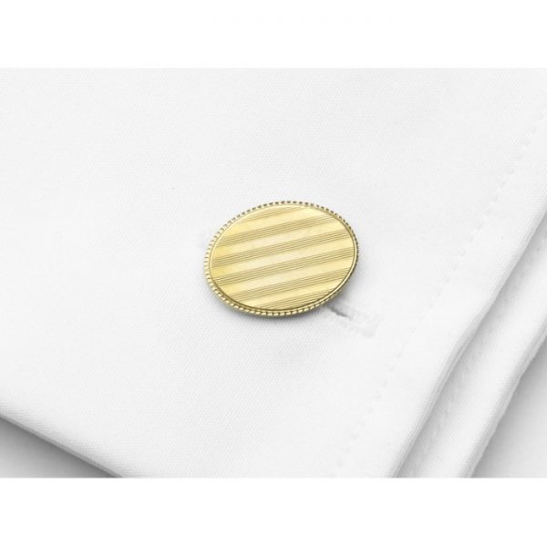 Bailey Banks and Biddle Gold Cufflinks; 14ct gold oval engine turned engraved with parallel lines accented by indented surround, Circa 1955