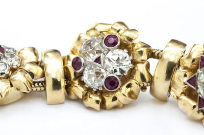 Vintage 7ct Diamond and Ruby Cluster Bracelet; set with 7.00 carats of diamonds and 3.00 carats of rubies in intricate and unique floral clusters surrounded by gold leaves, in 18ct yellow gold, Circa 1930s