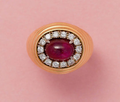 Vintage 3.25ct Burma Ruby and Diamond Cluster Dress Ring; high oval cabochon-cut 3.25ct unheated Burmese ruby surrounded by brilliant-cut diamonds, ribbed 18ct yellow gold shank. Austrian, Circa 1960
