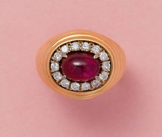Vintage 3.25ct Burma Ruby and Diamond Cluster Dress Ring; high oval cabochon-cut 3.25ct unheated Burmese ruby surrounded by brilliant-cut diamonds, ribbed 18ct yellow gold shank. Austrian, Circa 1960