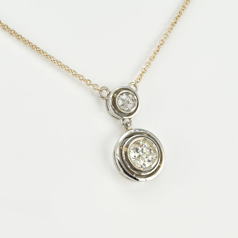Art Deco 1.15ct Twin Old Cut Diamond Solitaire Target Pendant, 0.85ct old European-cut diamond topped with 0.30ct old mine-cut diamond in 18ct white gold target settings to fixed 18ct yellow gold trace chain