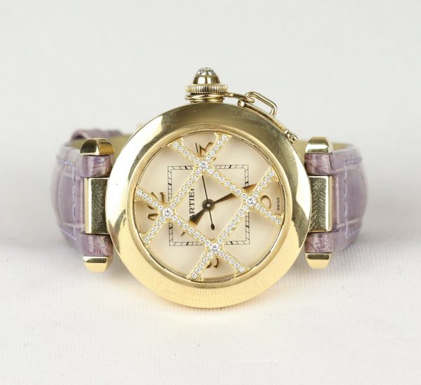 Cartier Pasha de Cartier 18ct Yellow Gold 2399 Ladies Automatic 32mm Wrist Watch With Removable Diamond Grill, white textured dial, Arabic numerals at 12, 3, 6 and 9 o'clock, sapphire crystal glass and a pavé set diamond crown cap. On a Cartier purple leather strap, with a Cartier 18ct yellow gold pin buckle.