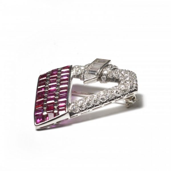 Vintage 1940s Ruby Diamond and Platinum Brooch; one side comprised of three columns of 5.25cts calibre-cut rubies, with 3.50cts fancy-cut and brilliant-cut diamonds set on the rest of the brooch
