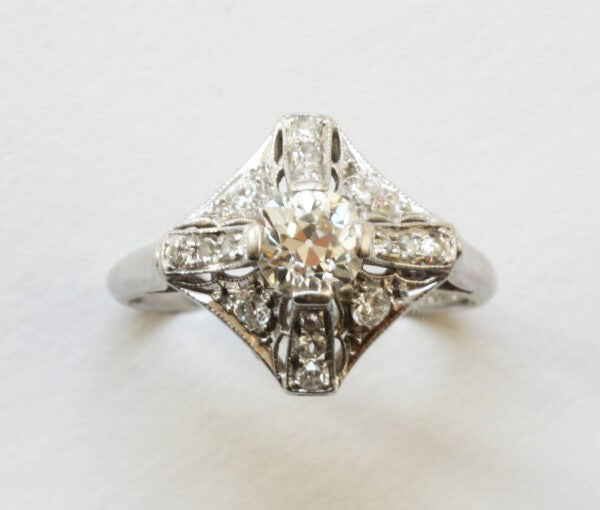 Art Deco Diamond and Platinum Dress Ring; 0.60ct brilliant cut diamond central to four diamond-set rectangular sections, accented with 0.90cts old-cut diamonds, Circa 1920