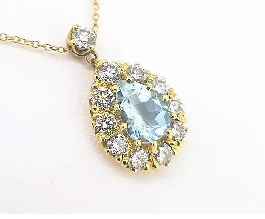 Aquamarine and Diamond Pear Shaped Cluster Pendant; pear-cut 1.65 carat aquamarine surrounded by 1.20cts brilliant diamonds, diamond bale, 18ct yellow gold