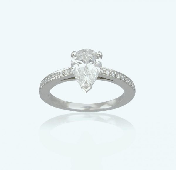 1.01ct Pear Cut Diamond Engagement Ring; central 1.01 carat pear-shaped diamond, claw-set, diamond set shoulders. Mounted in platinum.