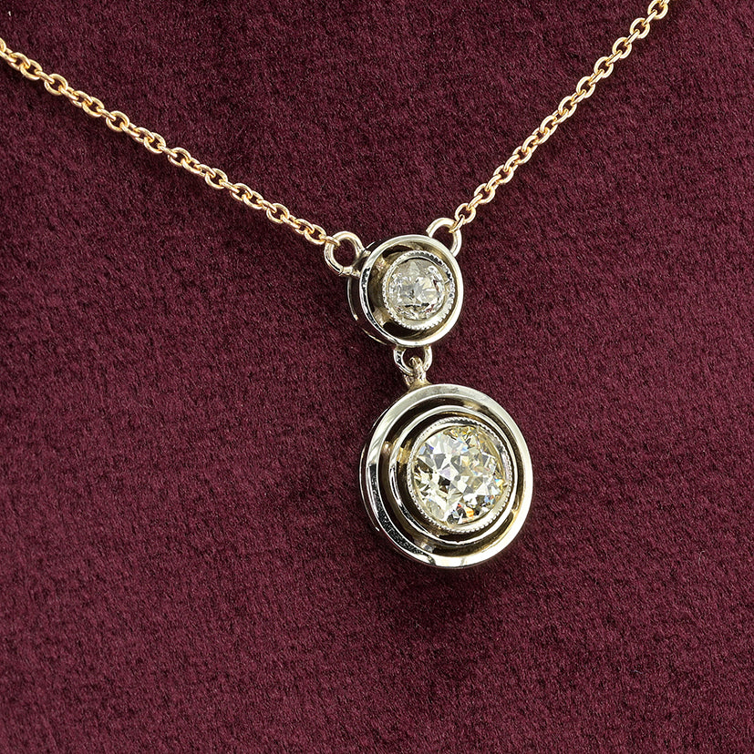 Art Deco 1.15ct Twin Old Cut Diamond Solitaire Target Pendant, 0.85ct old European-cut diamond topped with 0.30ct old mine-cut diamond in 18ct white gold target settings to fixed 18ct yellow gold trace chain