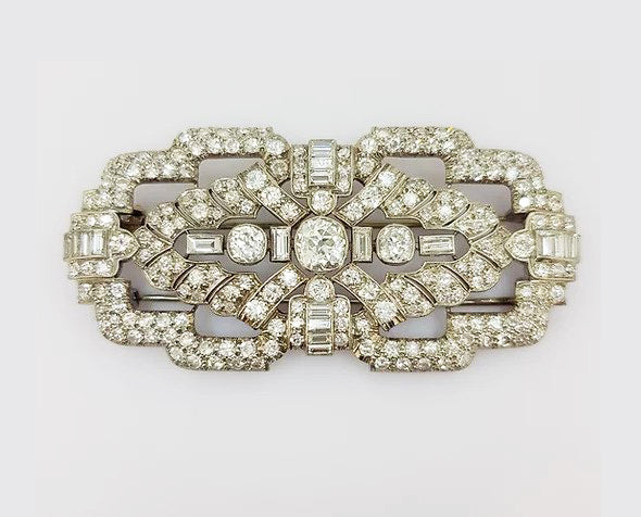 Antique Diamond and Platinum Brooch; A beautiful brooch crafted from platinum, the open-work design set with baguette-cut and circular-cut diamonds.