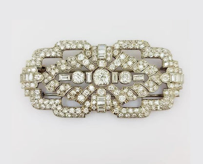Antique Diamond and Platinum Brooch; A beautiful brooch crafted from platinum, the open-work design set with baguette-cut and circular-cut diamonds.