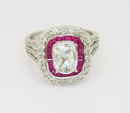 Oval Cut Diamond and Ruby Cluster Ring; oval-cut diamond surrounded by calibre-cut rubies and brilliant-cut diamonds, diamond set shoulders, 18ct white gold