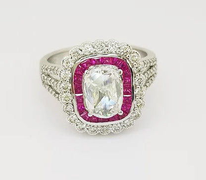 Oval Cut Diamond and Ruby Cluster Ring; oval-cut diamond surrounded by calibre-cut rubies and brilliant-cut diamonds, diamond set shoulders, 18ct white gold