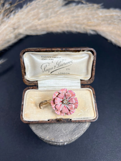 A pink enamelled flower brooch with a diamond centre, in yellow gold, in a box