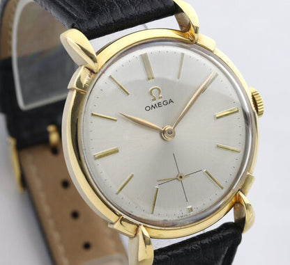 Omega Vintage Gents 18ct Yellow Gold 35mm Manual Watch, silver dial, teardrop lugs, smalls seconds sub-dial, acrylic crystal, on a black leather strap with Omega buckle, Circa 1950s