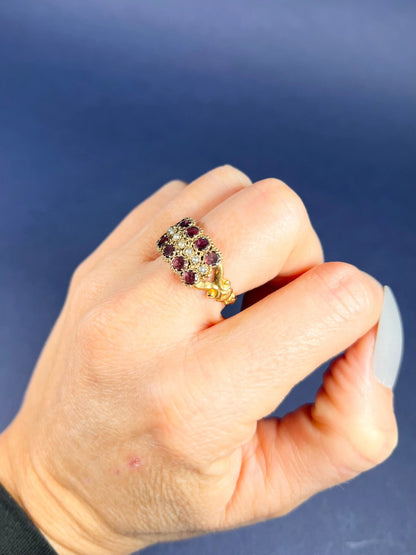 A yellow gold triple row ring with garnets and seed pearls, modelled on a hand