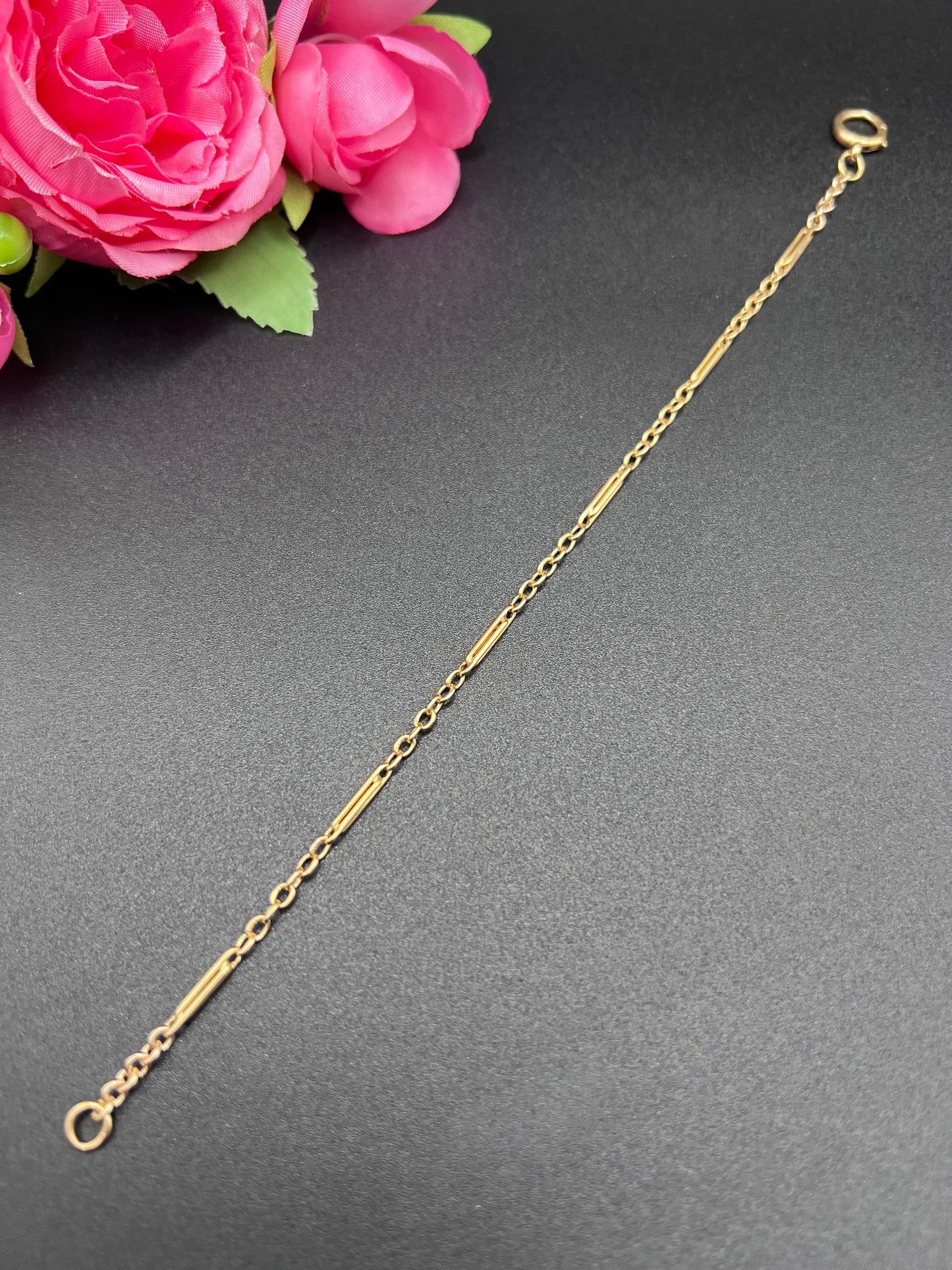 A yellow gold chain link bracelet with a bolt ring clasp