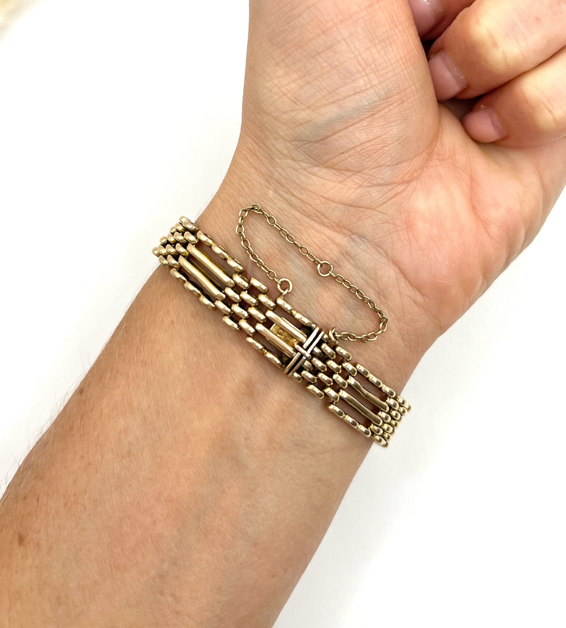 A yellow gold gate bracelet, modelled on a wrist