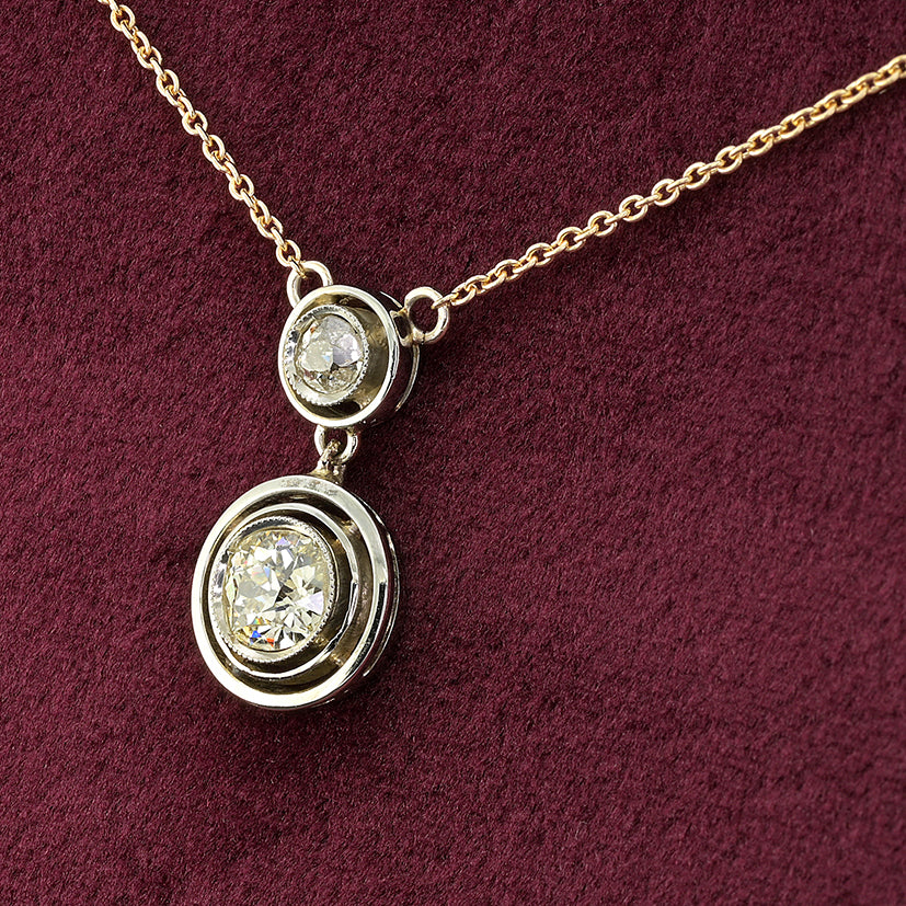 Art Deco 1.15ct Twin Old Cut Diamond Solitaire Target Pendant, 0.85ct old European-cut diamond topped with 0.30ct old mine-cut diamond in 18ct white gold target settings to fixed 18ct yellow gold trace chain